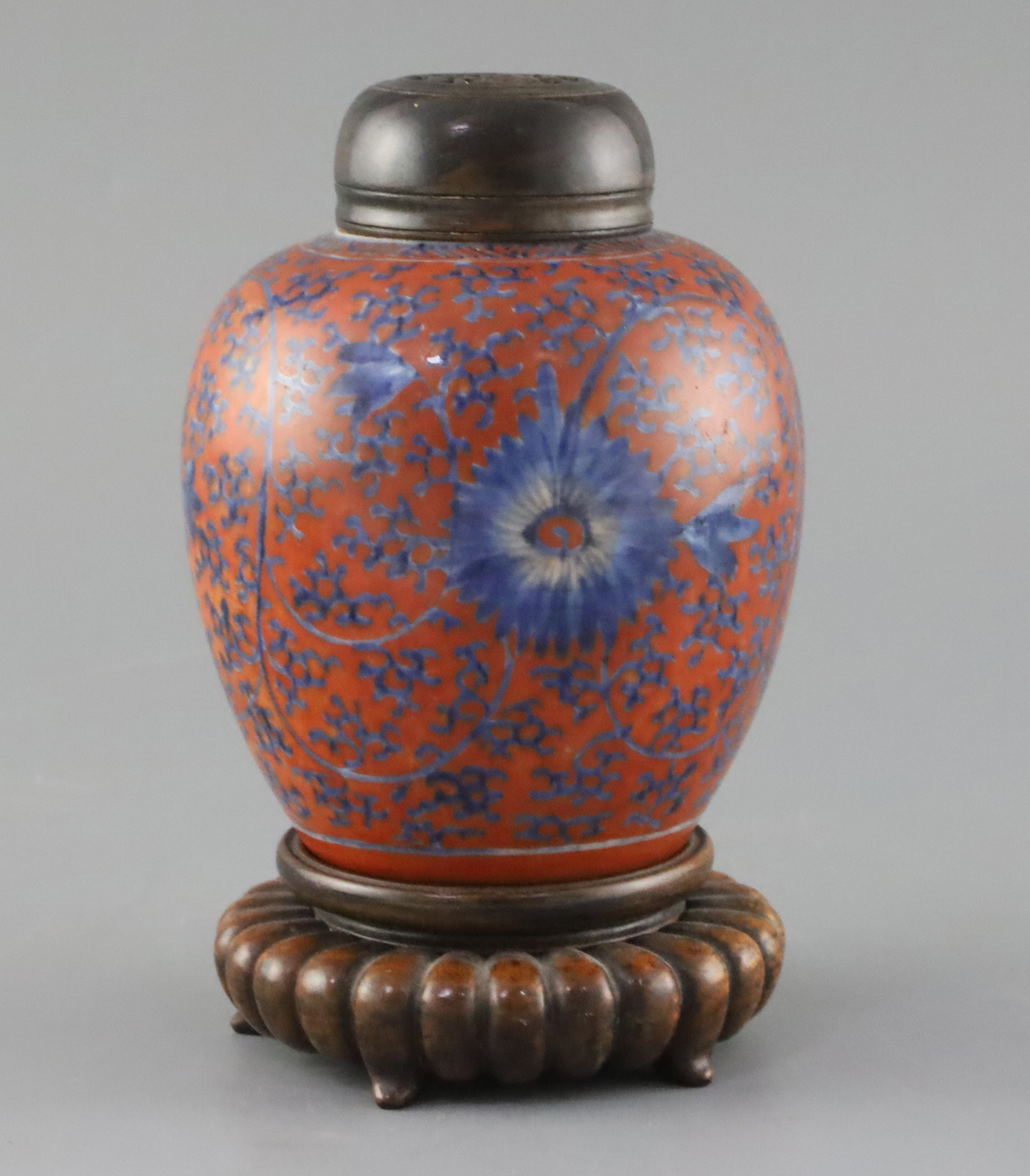 A Chinese coral red ground underglaze blue jar, Kangxi period, H. 12.3cm, excluding wood cover and stand